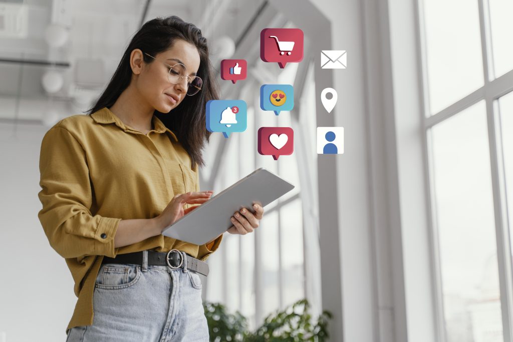 Young woman using a tablet with social media and digital marketing icons such as likes, shopping cart, notifications, heart, and email floating around, symbolizing online engagement and marketing."